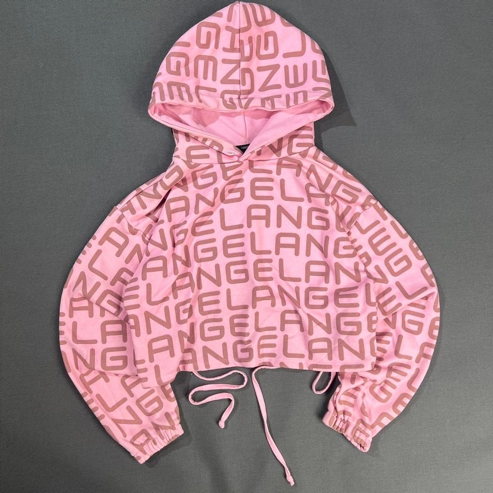 Pink Forever 21 cropped hoodie with all-over "ANGEL" graphic print.